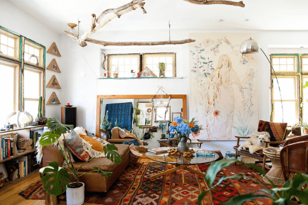 Photo of eclectic living space with plants, mix of new and vintage pieces to illustrate the sustainable boho chic trend