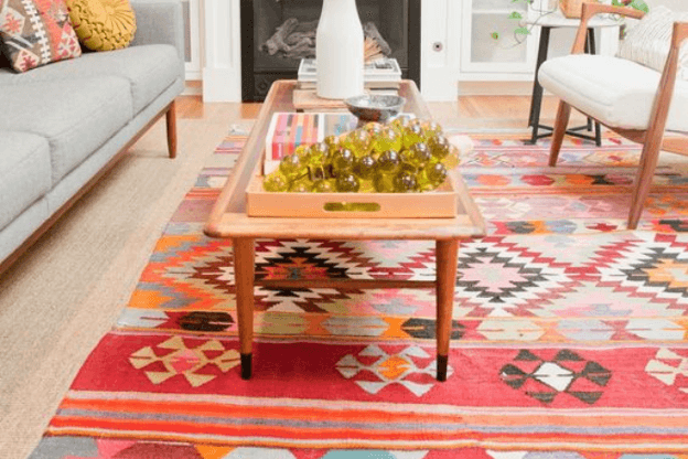 Photo of living room with vibrant multicolor geometric rug to illustrate the statement rug trend