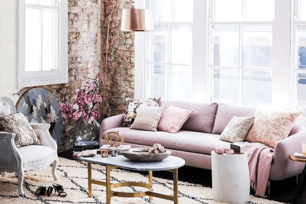 Photo of feminine living space with gold and rose gold accents to illustrate the mixed metals trend