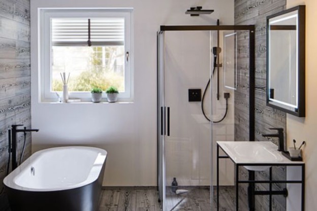 Modern bathroom with soaking tub, shower, and black hardware