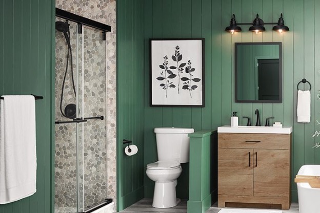 Green bathroom with earth-tone accents and river rock shower